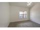 Bright bedroom with neutral carpeting and window at 8728 W Vale Dr, Phoenix, AZ 85037