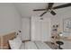 Cozy bedroom features a ceiling fan, closet, desk, and a comforting interior design at 8728 W Vale Dr, Phoenix, AZ 85037