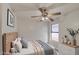 Well-lit bedroom with ceiling fan, natural light, cozy decor, and calming color scheme at 8728 W Vale Dr, Phoenix, AZ 85037
