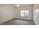 Spacious bedroom with ceiling fan and window at 8728 W Vale Dr, Phoenix, AZ 85037