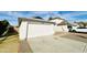 House exterior featuring a white garage door and a gravel driveway at 8728 W Vale Dr, Phoenix, AZ 85037