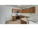 Updated kitchen with wood cabinets and stainless steel appliances at 8728 W Vale Dr, Phoenix, AZ 85037