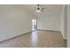 Living room with tile floors, sliding glass door, and ceiling fan at 8728 W Vale Dr, Phoenix, AZ 85037