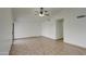 Living room with tile floors and a ceiling fan, offering an open layout at 8728 W Vale Dr, Phoenix, AZ 85037