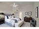 Spacious main bedroom featuring a ceiling fan, stylish furnishings, and modern decor at 8728 W Vale Dr, Phoenix, AZ 85037