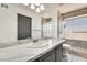 Modern bathroom with marble countertop vanity and tiled shower at 8818 W Virginia Ave, Phoenix, AZ 85037