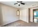 Bedroom featuring a ceiling fan, carpet flooring, a window and a built-in closet at 8818 W Virginia Ave, Phoenix, AZ 85037