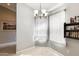 A well-lit dining area featuring light gray walls, a chandelier, and decorative curtains at 8818 W Virginia Ave, Phoenix, AZ 85037