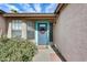 Close-up of the home's entrance featuring a charming front door and desert landscaping at 8818 W Virginia Ave, Phoenix, AZ 85037