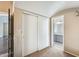 Hallway view of bathroom with large mirror vanity and sliding door closet at 8818 W Virginia Ave, Phoenix, AZ 85037