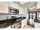 Well-equipped kitchen featuring stainless steel appliances, modern lighting, and ample counter space at 8818 W Virginia Ave, Phoenix, AZ 85037