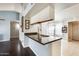 Open kitchen area featuring a breakfast bar with granite countertops and stainless steel sink at 8818 W Virginia Ave, Phoenix, AZ 85037