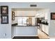 View of the kitchen from the living room, showing granite countertop and stainless steel appliances at 8818 W Virginia Ave, Phoenix, AZ 85037