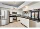 Bright kitchen with stainless steel appliances, black granite countertops, and ample cabinet space at 8818 W Virginia Ave, Phoenix, AZ 85037