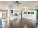 Open living room and kitchen area with hardwood flooring and ceiling fans at 8818 W Virginia Ave, Phoenix, AZ 85037