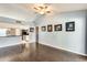 Open floor plan in the living room, with hardwood floors, a breakfast bar, and light blue walls at 8818 W Virginia Ave, Phoenix, AZ 85037