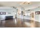 Living room featuring wood flooring, a breakfast bar, and light blue walls at 8818 W Virginia Ave, Phoenix, AZ 85037