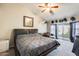 Tranquil main bedroom with ceiling fan and access to the backyard at 8818 W Virginia Ave, Phoenix, AZ 85037