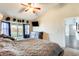 Calm main bedroom with ceiling fan and access to outdoor living spaces at 8818 W Virginia Ave, Phoenix, AZ 85037