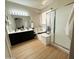 Bright bathroom showcasing a double sink vanity, a soaking tub, and a sleek glass-enclosed shower at 9024 W Alda Way, Peoria, AZ 85382