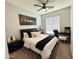 Comfortable bedroom with modern decor, ceiling fan, and a moon phases wall art at 9024 W Alda Way, Peoria, AZ 85382