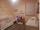 Adorable Bedroom with crib, changing table, and plenty of storage at 9024 W Alda Way, Peoria, AZ 85382