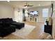 Inviting living room features a plush sofa, wood floors, neutral decor, and a large window at 9024 W Alda Way, Peoria, AZ 85382