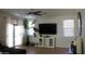 Bright living room featuring a large TV and sliding glass doors at 9024 W Alda Way, Peoria, AZ 85382