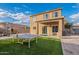 Two-story home with backyard, ping pong table, and grassy area at 909 W Elm Ave, Coolidge, AZ 85128