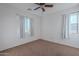 Bright bedroom with carpet flooring and two windows at 909 W Elm Ave, Coolidge, AZ 85128