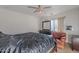 Bedroom with ceiling fan, dresser, chair, and bed at 909 W Elm Ave, Coolidge, AZ 85128