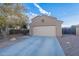 Two-story house with beige exterior and attached garage at 909 W Elm Ave, Coolidge, AZ 85128