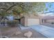 Two-story house with beige exterior, landscaping, and driveway at 909 W Elm Ave, Coolidge, AZ 85128