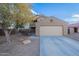 Two-story house with beige exterior, landscaping, and driveway at 909 W Elm Ave, Coolidge, AZ 85128