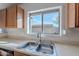 Kitchen features double sink and a view of the backyard at 909 W Elm Ave, Coolidge, AZ 85128