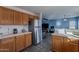 Kitchen with stainless steel refrigerator and view of living room at 909 W Elm Ave, Coolidge, AZ 85128