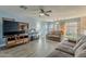 Living room with gray sofas, wood floors, and large TV at 909 W Elm Ave, Coolidge, AZ 85128