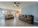 Living room with gray sofas, wood floors, and a ceiling fan at 909 W Elm Ave, Coolidge, AZ 85128