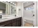 Bathroom with double vanity, marble countertops, and a soaking tub at 956 W Hudson Way, Gilbert, AZ 85233