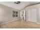 Well-lit bedroom with wood-look flooring and access to a hallway at 956 W Hudson Way, Gilbert, AZ 85233