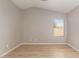 Bright bedroom featuring a large window and wood-look flooring at 956 W Hudson Way, Gilbert, AZ 85233