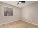 Simple bedroom with wood-look flooring and a window with blinds at 956 W Hudson Way, Gilbert, AZ 85233