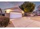 House exterior featuring a white garage door and desert landscaping at 956 W Hudson Way, Gilbert, AZ 85233