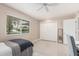 Bedroom with double-door closet and ceiling fan at 9601 W Greenhurst Dr, Sun City, AZ 85351