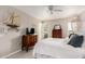 Bright bedroom with a ceiling fan and built-in shelving at 9601 W Greenhurst Dr, Sun City, AZ 85351