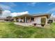 Exterior view showing the back of the house and a well-maintained yard at 9601 W Greenhurst Dr, Sun City, AZ 85351