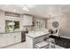 Modern kitchen featuring white cabinets, granite countertops, and an island at 9601 W Greenhurst Dr, Sun City, AZ 85351