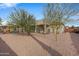Landscaped backyard with gravel, trees, and a view of the pool and gazebo at 1040 N 113Th Pl, Mesa, AZ 85207