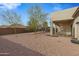 Spacious backyard with gravel, trees, and a view of the pool and gazebo at 1040 N 113Th Pl, Mesa, AZ 85207