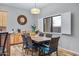 Bright dining area with wood table, wicker chairs and view to backyard at 1040 N 113Th Pl, Mesa, AZ 85207